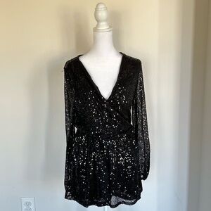 Stylish black long-sleeve romper in size XS.